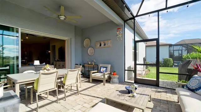 a living room with furniture and a flat screen tv with wooden floor