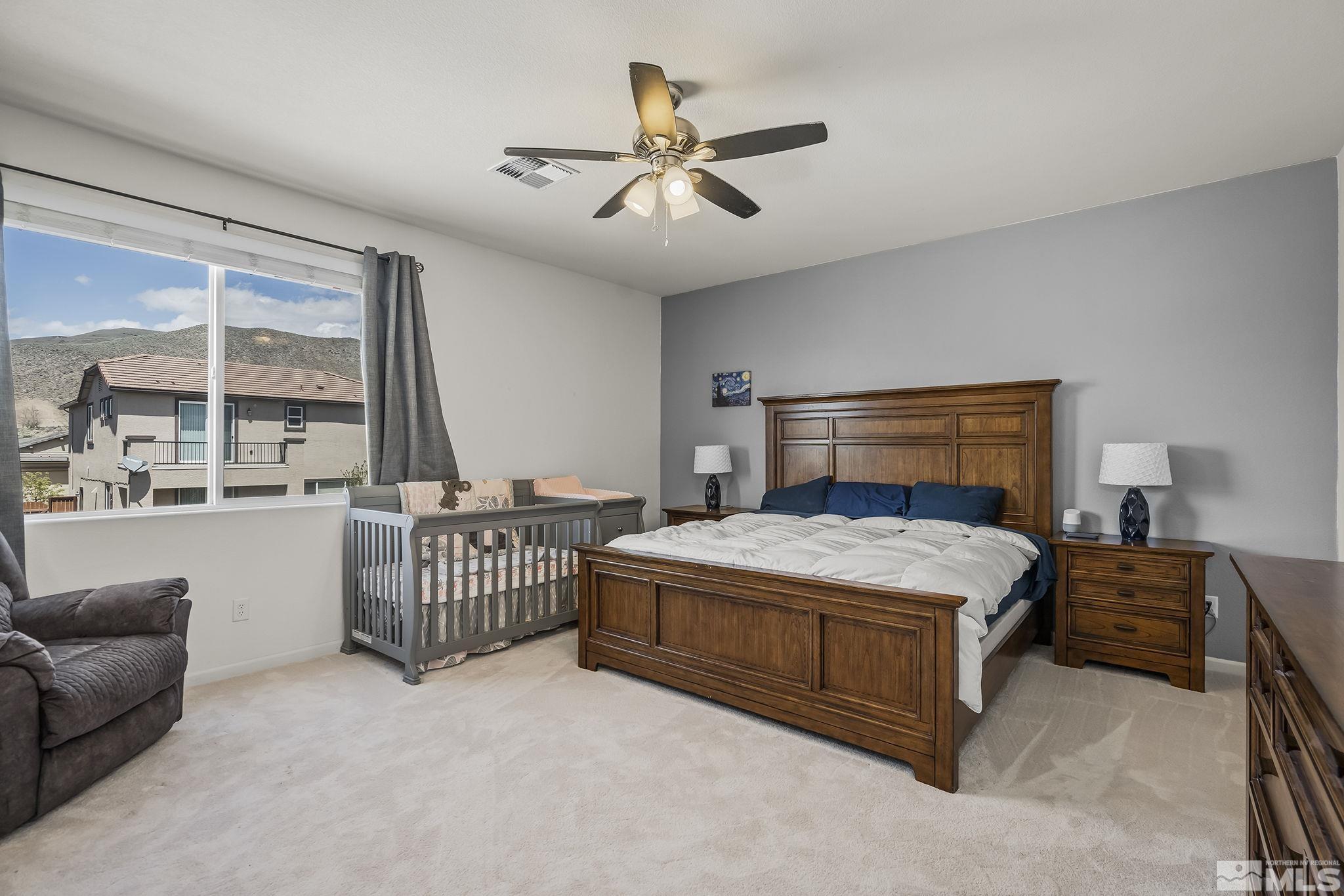2835 Bonfire Lane Reno, NV 89521 - Photo 12 of 28 a bedroom with a bed and a chandelier