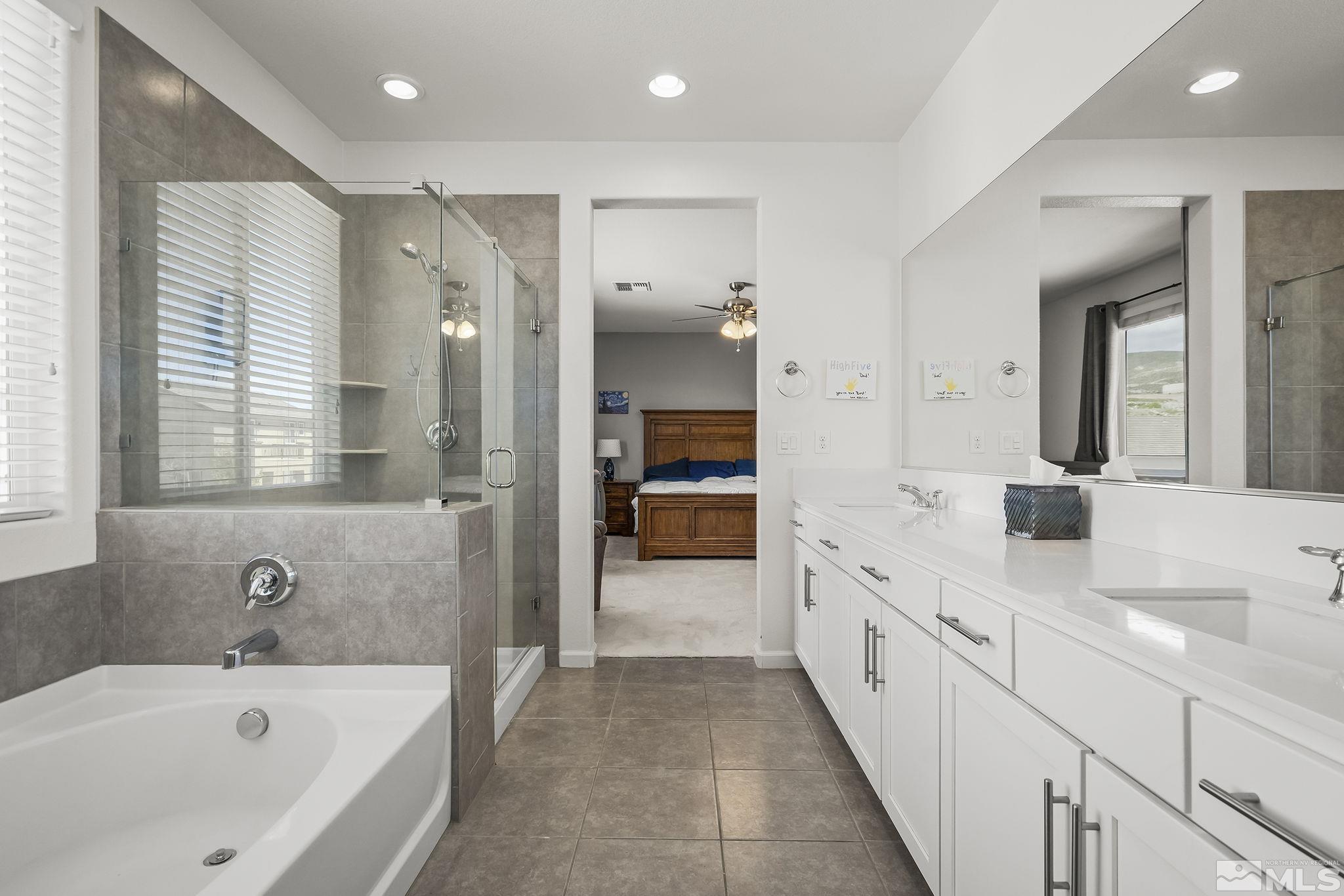 2835 Bonfire Lane Reno, NV 89521 - Photo 14 of 28 a bathroom with a tub a sink and mirror