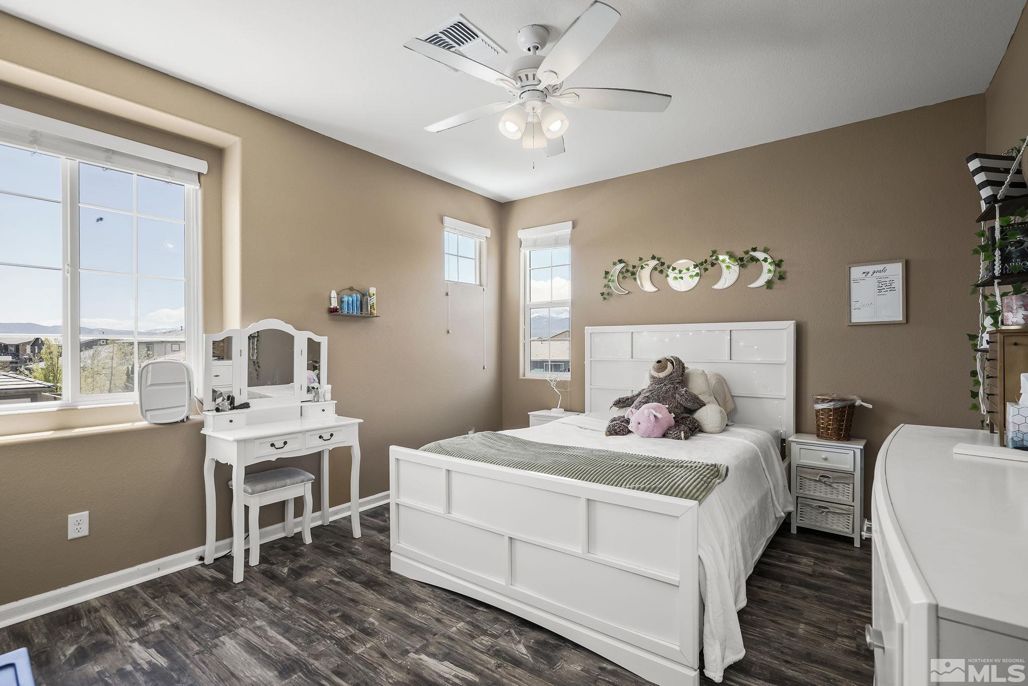2835 Bonfire Lane Reno, NV 89521 - Photo 19 of 28 a bedroom with a bed and a chandelier