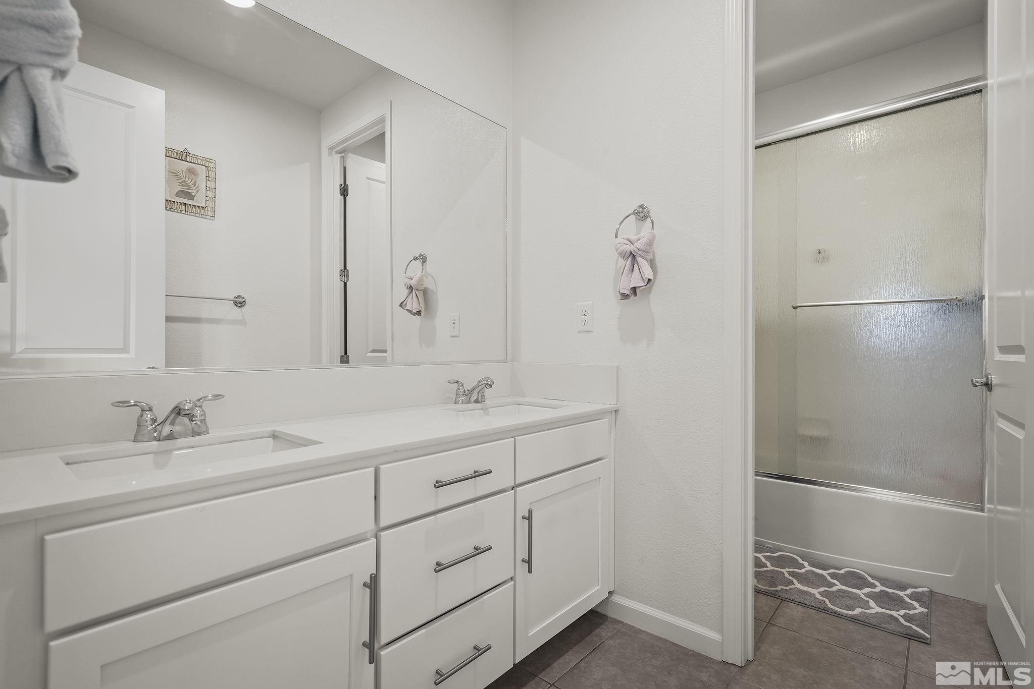2835 Bonfire Lane Reno, NV 89521 - Photo 20 of 28 a bathroom with a shower sink and mirror