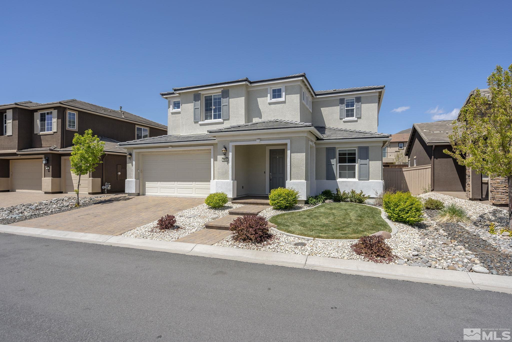 2835 Bonfire Lane Reno, NV 89521 - Photo 2 of 28 a front view of a house with garden and plants