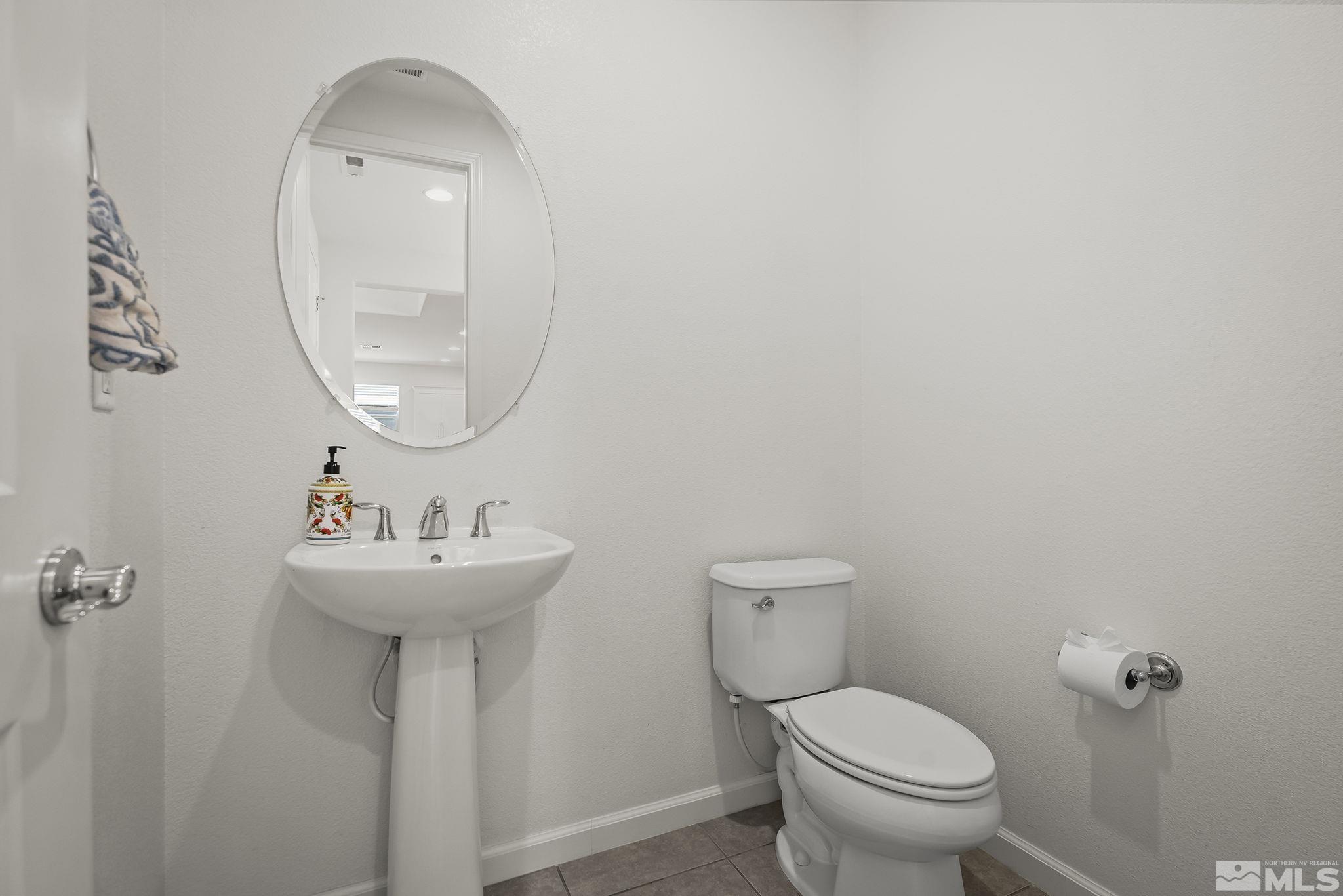 2835 Bonfire Lane Reno, NV 89521 - Photo 23 of 28 a bathroom with a toilet sink and mirror