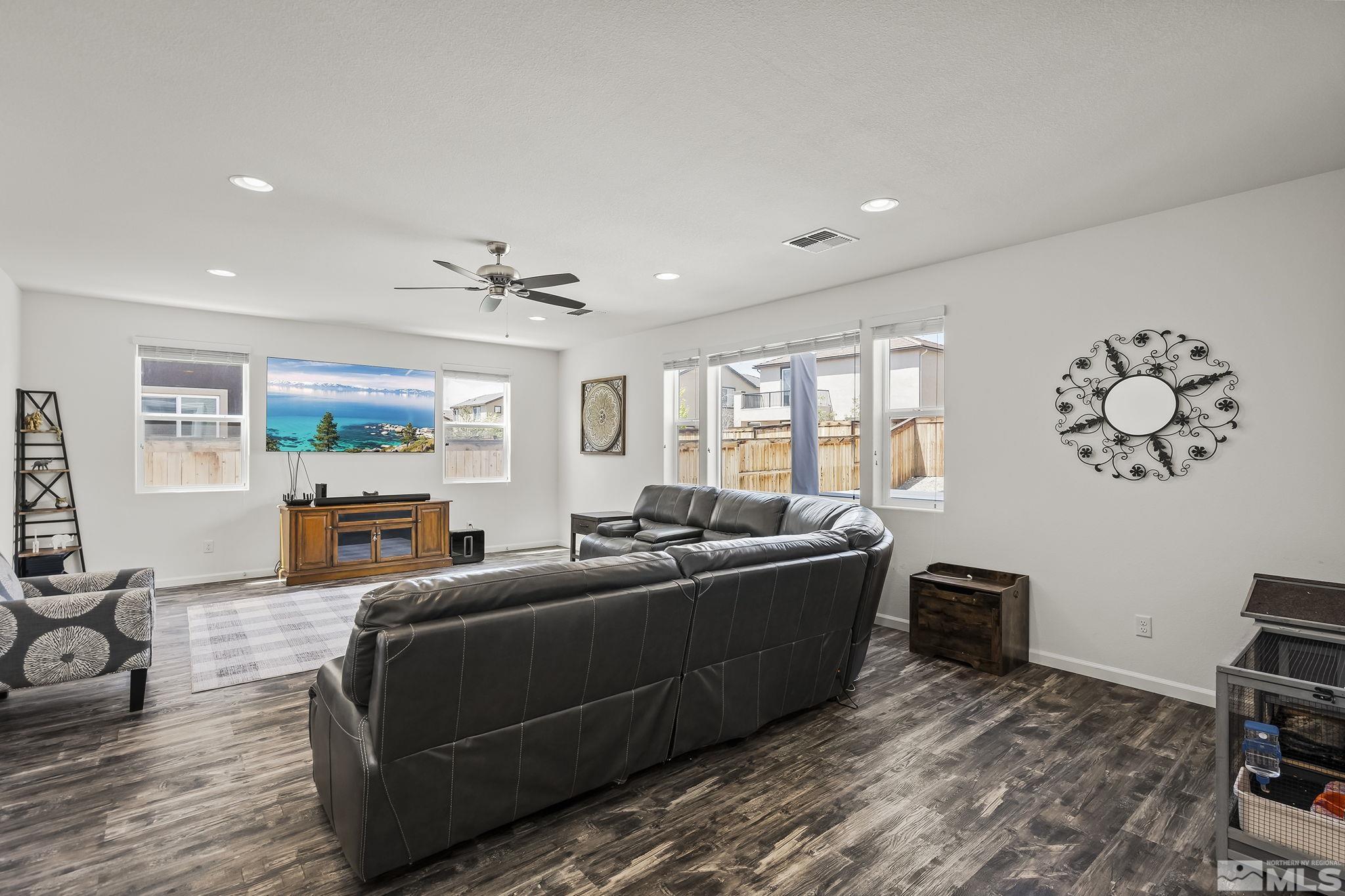 2835 Bonfire Lane Reno, NV 89521 - Photo 4 of 28 a living room with furniture a flat screen tv and a large window