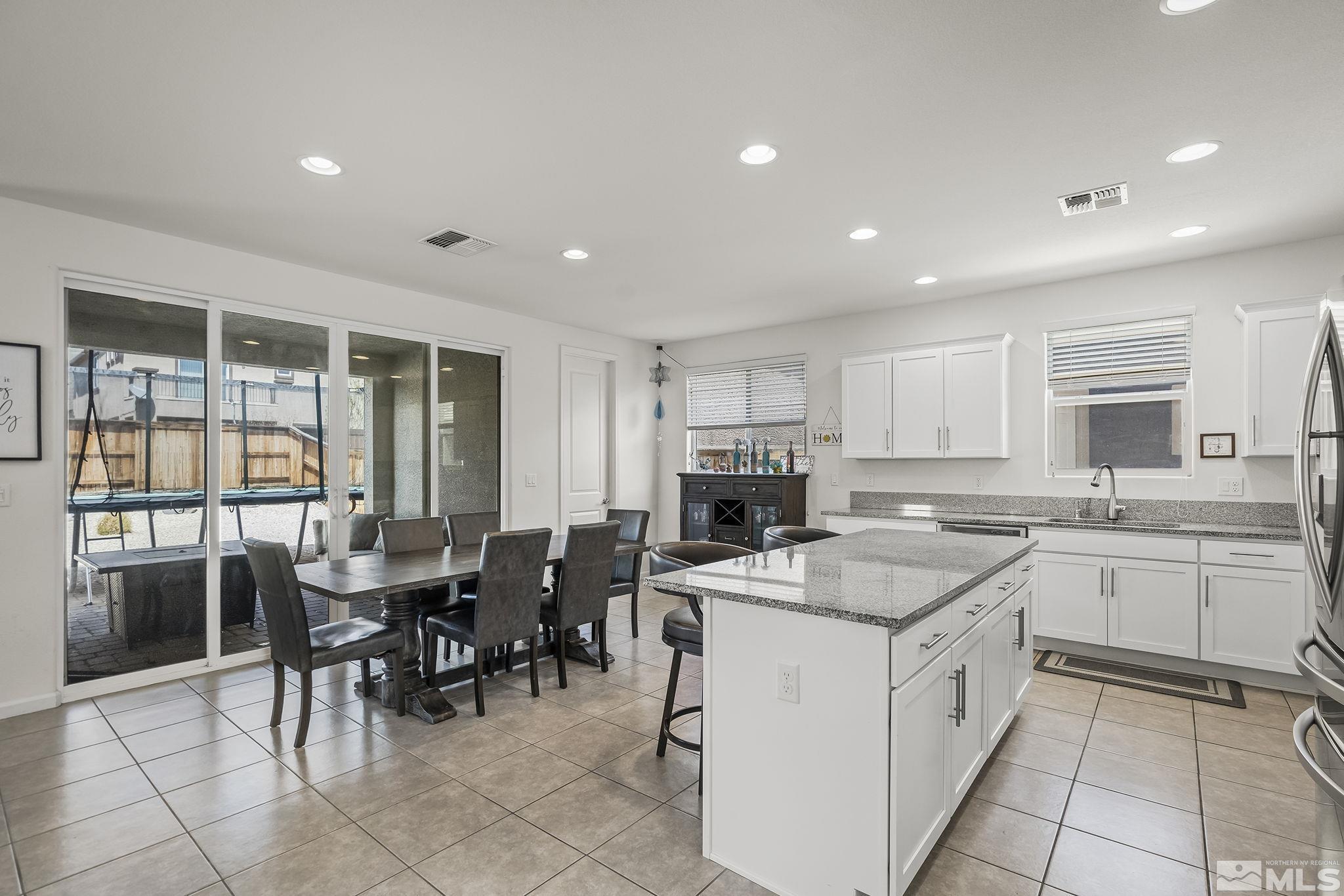 2835 Bonfire Lane Reno, NV 89521 - Photo 5 of 28 a kitchen with appliances a sink counter space and chairs in it