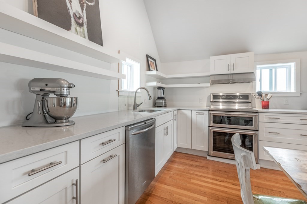 106 Upland Road Winthrop, MA 02152 - Photo 11 of 37 a kitchen with kitchen island a sink appliances and cabinets