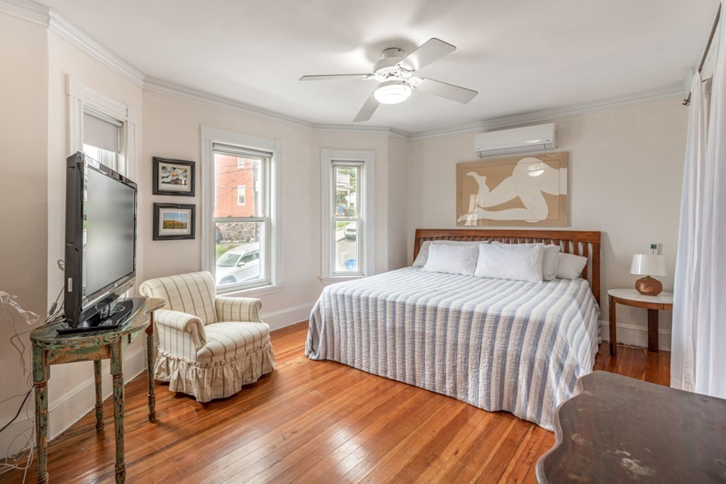 106 Upland Road Winthrop, MA 02152 - Photo 15 of 37 a bedroom with a bed and a flat screen tv