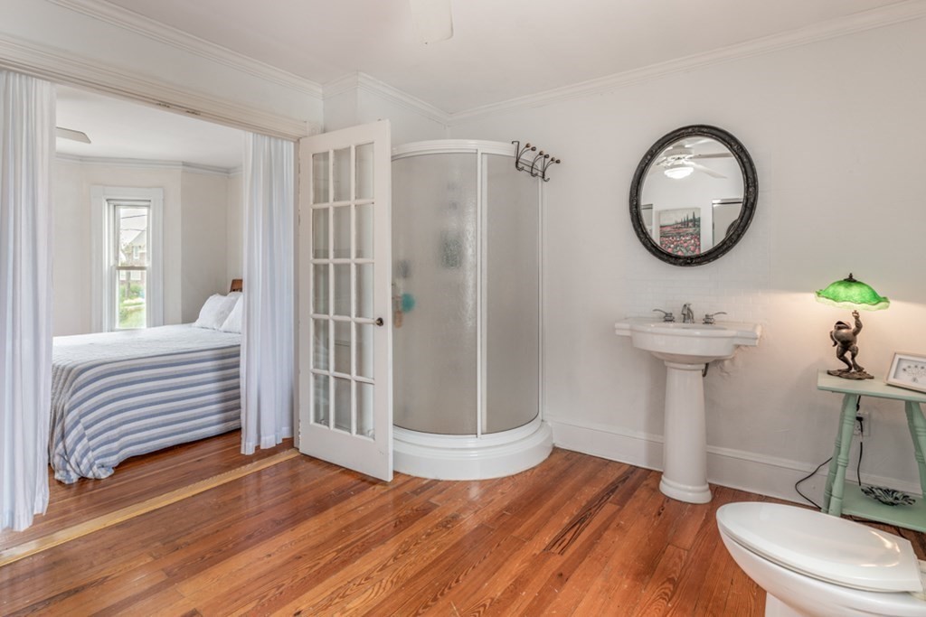 106 Upland Road Winthrop, MA 02152 - Photo 17 of 37 a bathroom with a toilet a sink and mirror