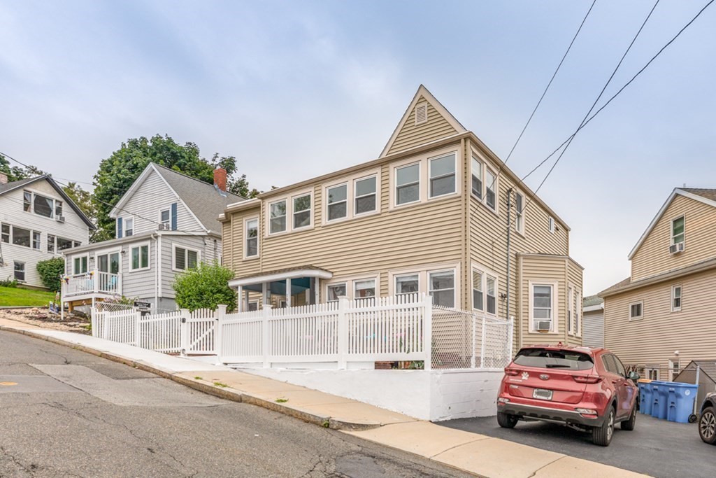 106 Upland Road Winthrop, MA 02152 - Photo 2 of 37 a car parked in front of a white house