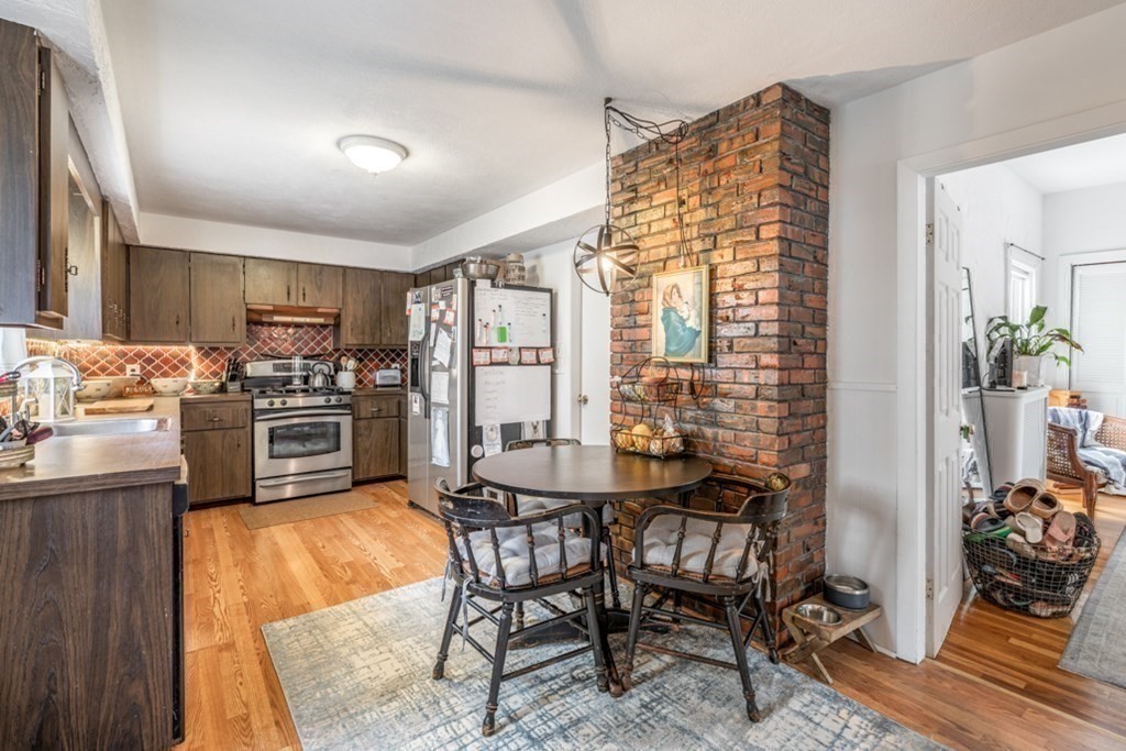 106 Upland Road Winthrop, MA 02152 - Photo 24 of 37 a kitchen with a table chairs stove and refrigerator