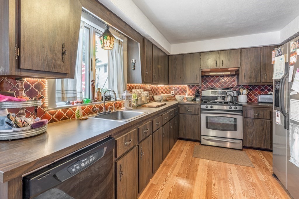 106 Upland Road Winthrop, MA 02152 - Photo 25 of 37 a kitchen with a sink stove and cabinets