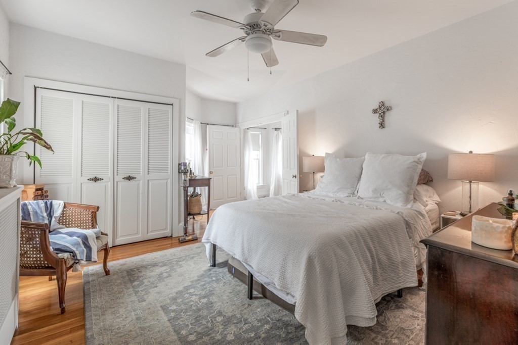 106 Upland Road Winthrop, MA 02152 - Photo 28 of 37 a spacious bedroom with a bed and a chandelier