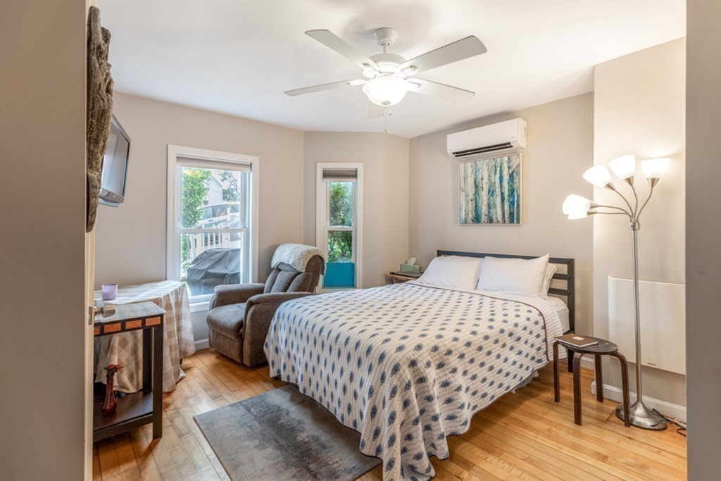 106 Upland Road Winthrop, MA 02152 - Photo 32 of 37 a bedroom with a bed a chandelier and a window