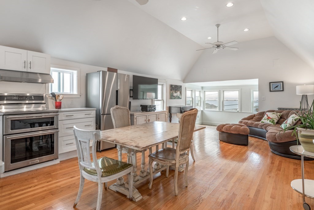 106 Upland Road Winthrop, MA 02152 - Photo 8 of 37 a kitchen with stainless steel appliances a dining table chairs stove and refrigerator
