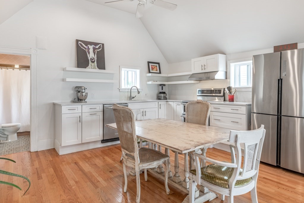 106 Upland Road Winthrop, MA 02152 - Photo 10 of 37 a kitchen with stainless steel appliances granite countertop a dining table chairs refrigerator and sink