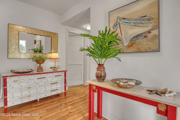 a spacious bedroom with a bed and a flat screen tv