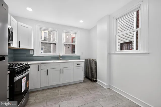 a kitchen that has a sink and a stove