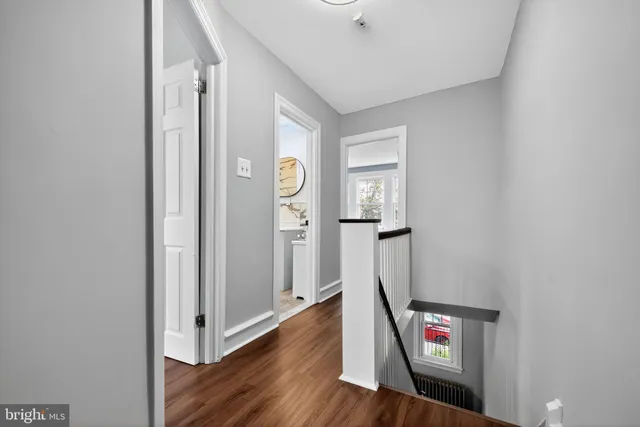 an entryway to room with wooden floor