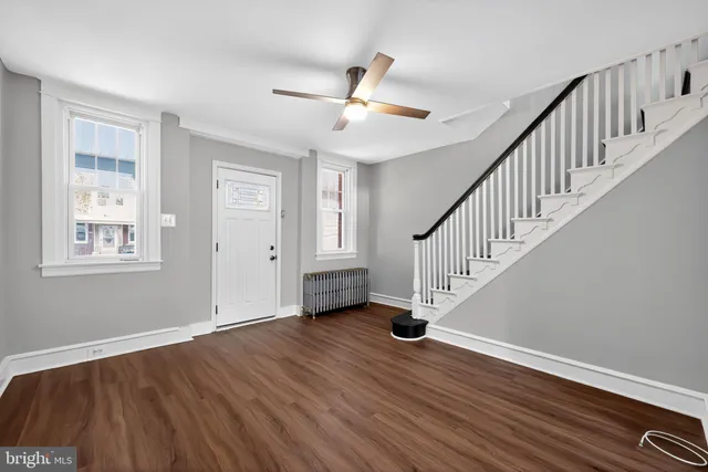 a view of an entryway with wooden floor