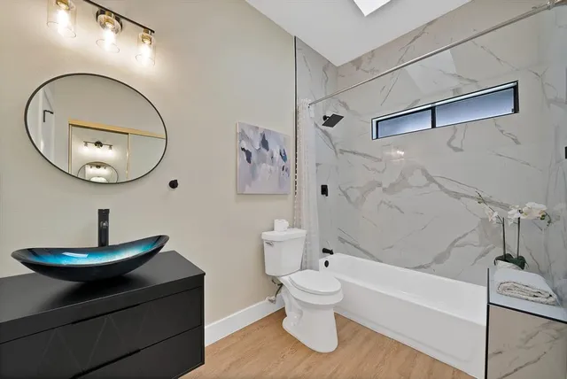 a bathroom with a toilet and a mirror
