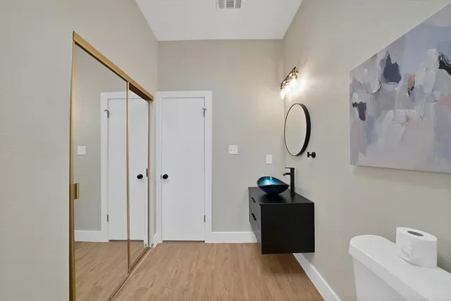 a bedroom with a bed and a mirror