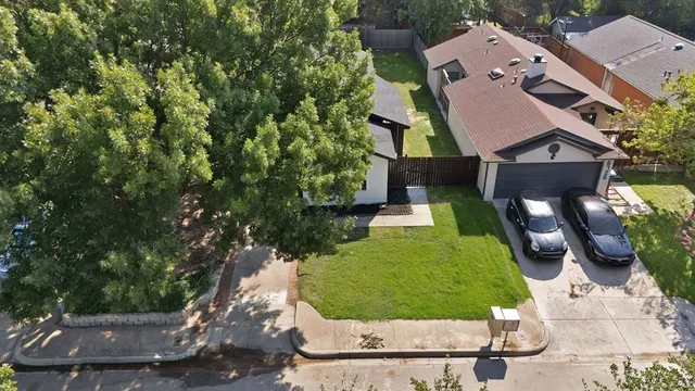 an aerial view of a house with a yard and lake view