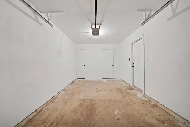 a view of a hallway with a chandelier fan