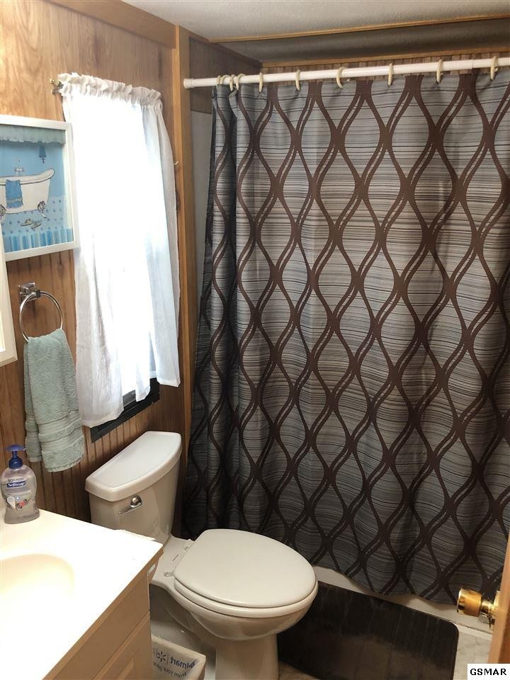 1403 Lin Creek Road Sevierville, TN 37876 - Photo 17 of 24 a white toilet sitting next to a shower curtain