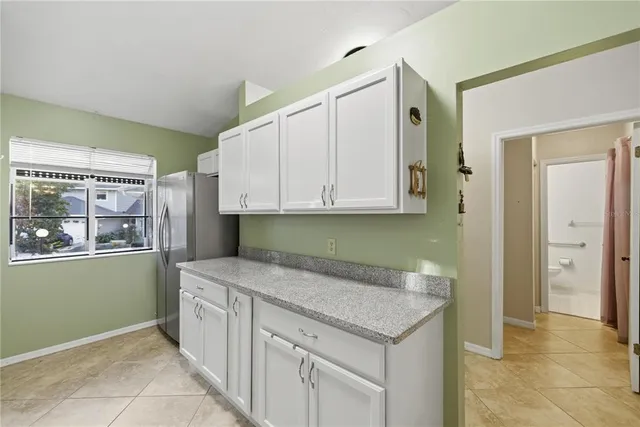 a kitchen with granite countertop a sink and cabinets