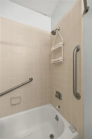 a bathroom with a tub and shower