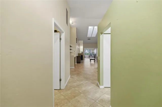 a view of a hallway with a view of living room