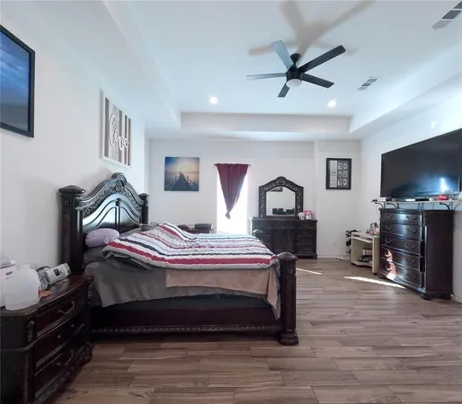 a bedroom with a bed and wooden floor