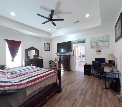 a bedroom with a bed and a flat screen tv