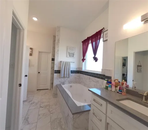 a bathroom with a bathtub and a shower
