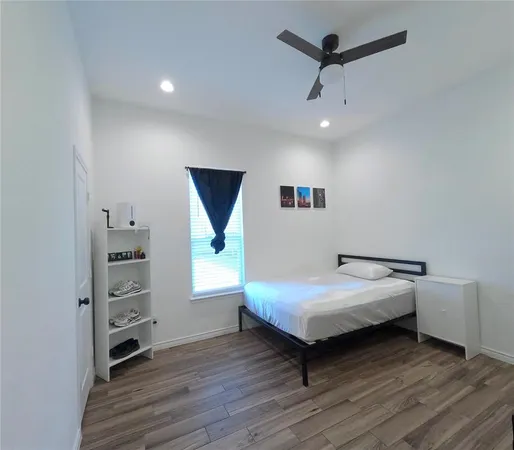 a bedroom with a bed a desk and chair