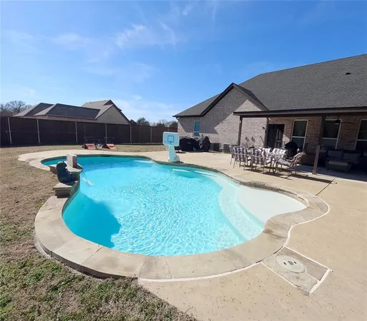 a swimming pool with outdoor seating and yard