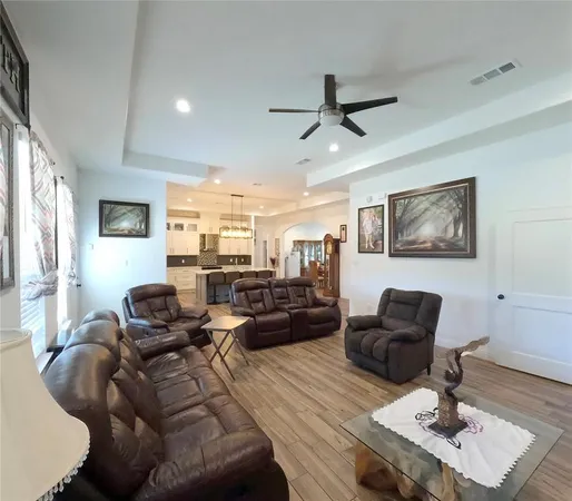 a living room with furniture and a wooden floor