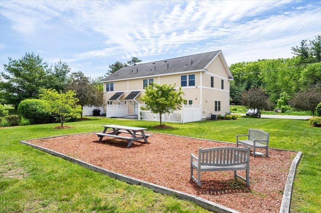 6 Bates Street, Unit A Devens, MA 01434 - Photo 4 of 41 a front view of a house with garden