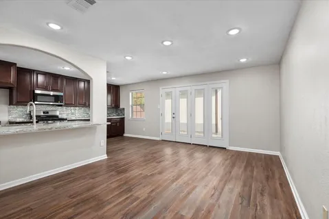 a view of kitchen with wooden floor and electronic appliances