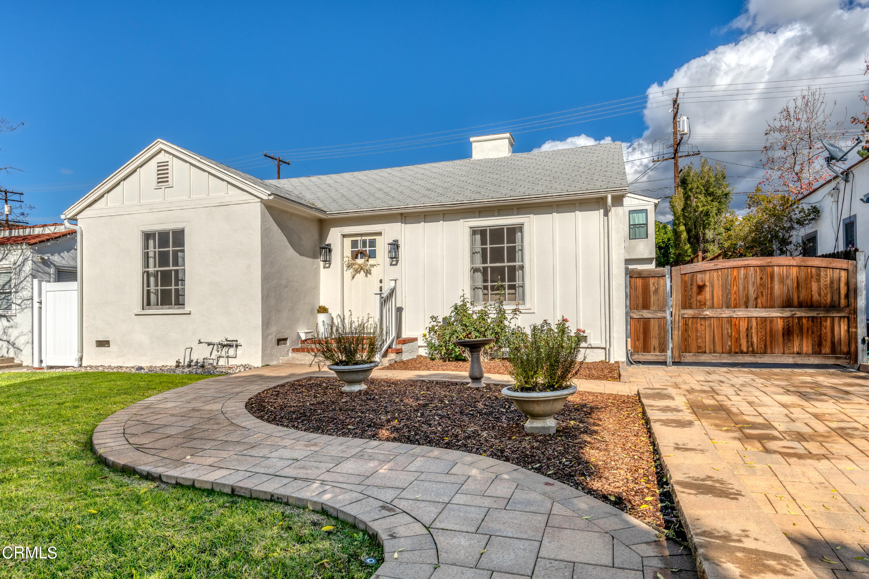 a view of a house with backyard and sitting area