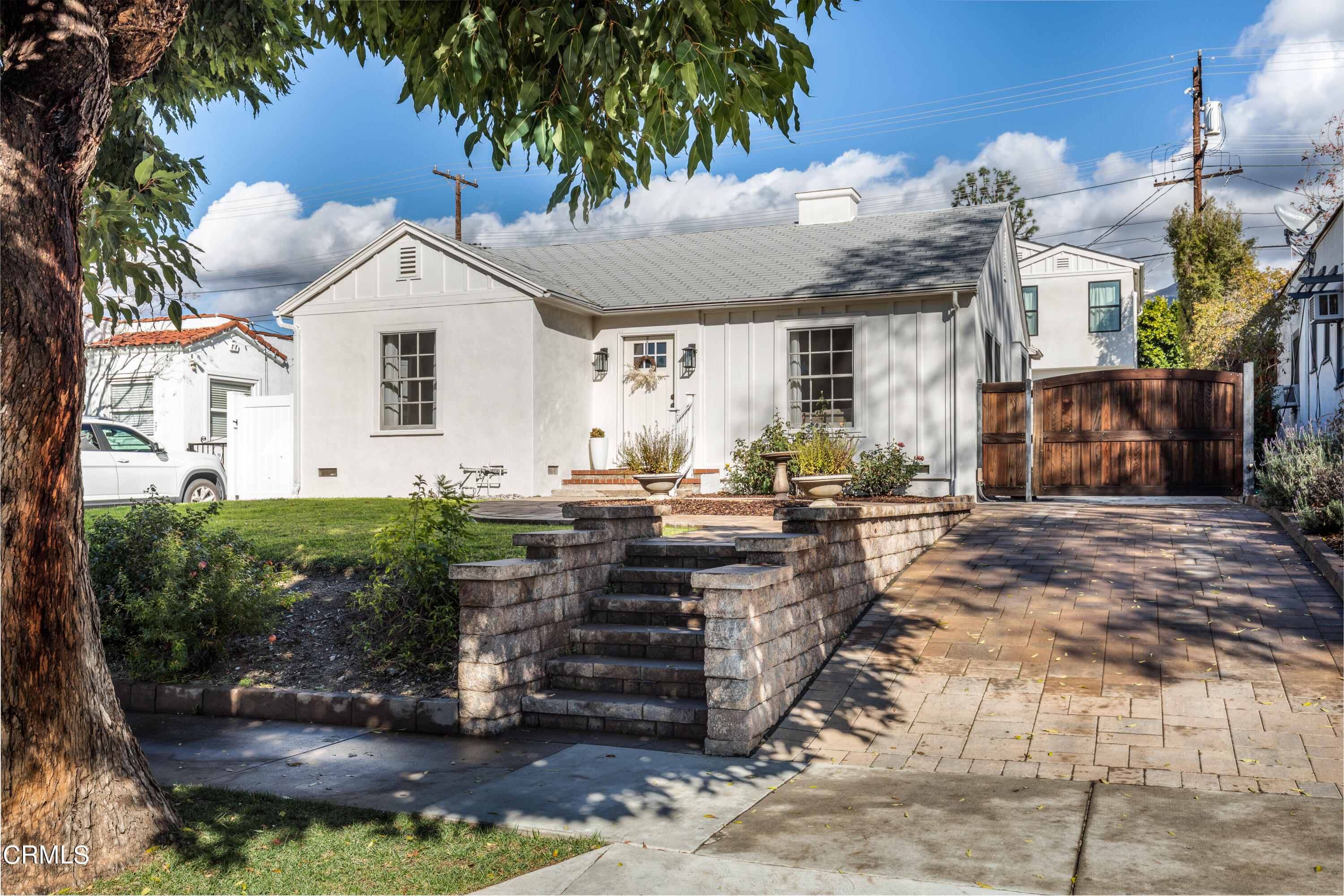 1539 Broadview Drive Glendale, CA 91208 - Photo 19 of 19 a view of a white house next to a yard with plants and palm trees