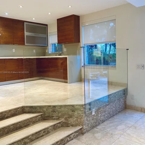 a kitchen with a sink and a stove top oven