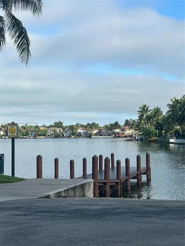 a dining room with furniture and a floor to ceiling window