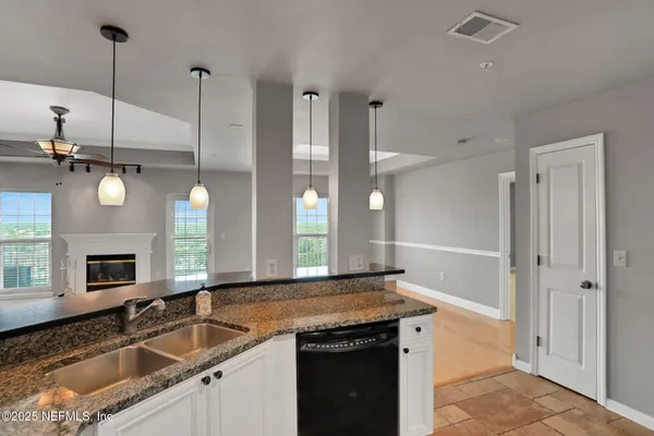 a view of a kitchen with a sink and a refrigerator