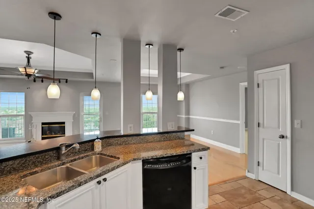 a view of a kitchen with a sink and a refrigerator