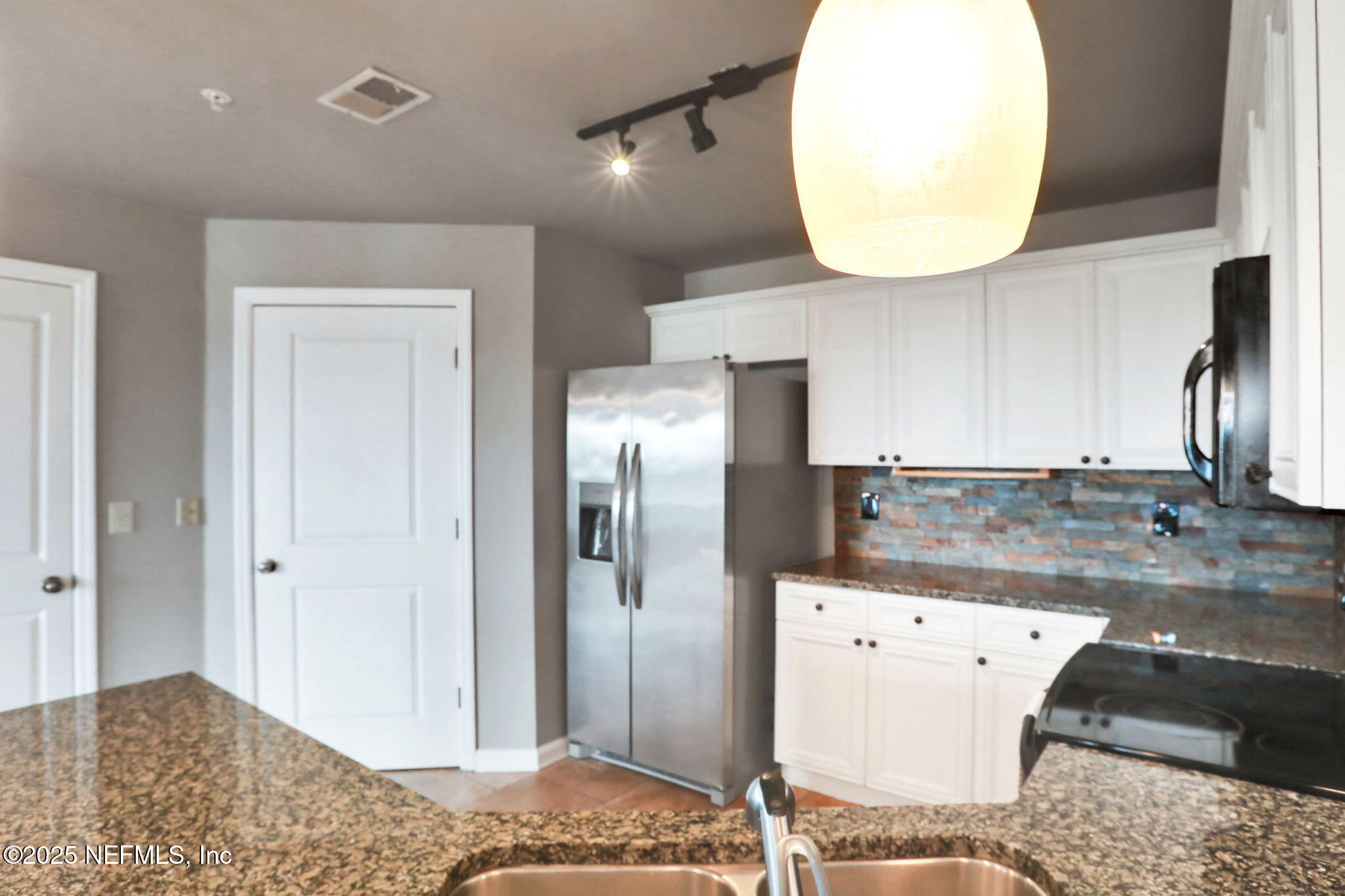 400 East Bay Street, Unit 1705 Jacksonville, FL 32202 - Photo 13 of 68 a view of a kitchen with a sink and a refrigerator