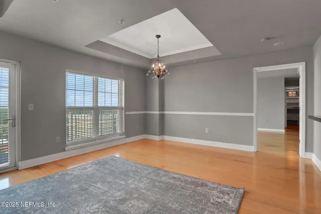 a living room with a fireplace and a floor to ceiling window