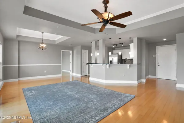 a view of empty room with wooden floor and fireplace