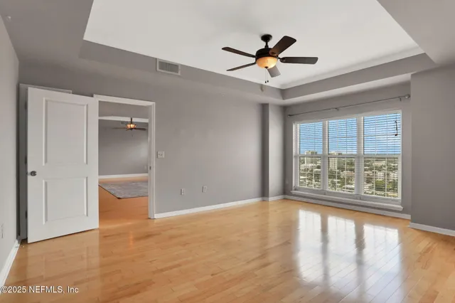 wooden floor in an empty room with a window