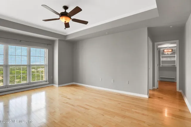 an empty room with chandelier fan
